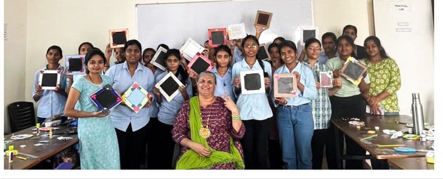 Students holding their miniature artworks at the exhibition